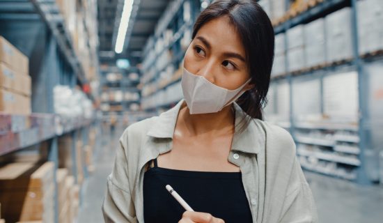 young-asian-businesswoman-manager-wearing-face-mask-warehouse-using-digital-tablet-checking-inventory